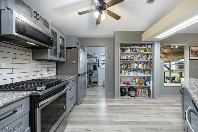 a kitchen with a refrigerator and a sink