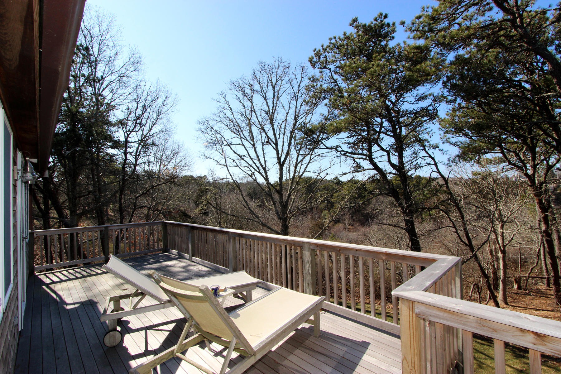 51 Woods Neck Road Orleans, MA 02653 - Photo 23 of 51 a view of a deck with furniture and trees