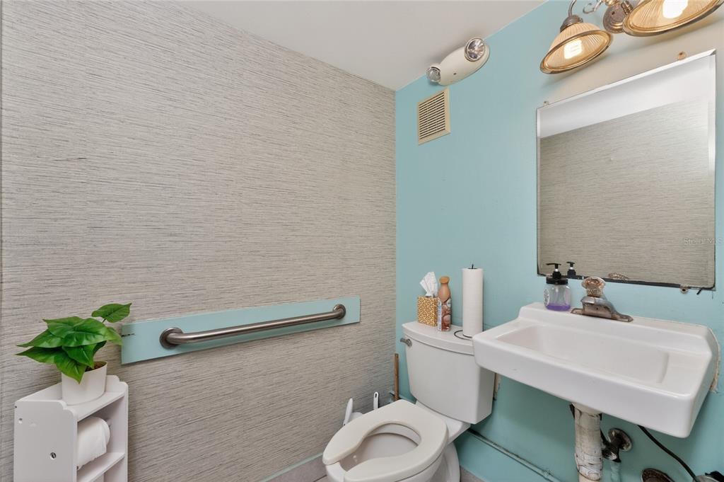 4275 South Access Road Englewood, FL 34224 - Photo 18 of 24 a bathroom with a sink mirror and toilet