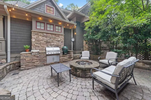 a living room with furniture fireplace and a large window