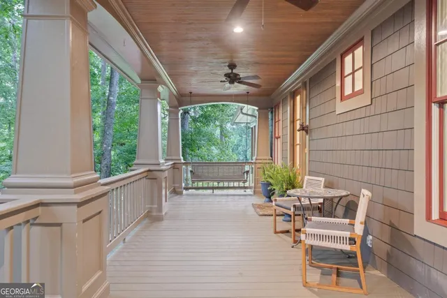 a living room with furniture kitchen view and a chandelier