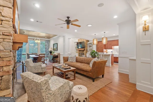 a kitchen with stainless steel appliances granite countertop a refrigerator a sink dishwasher and wooden cabinets