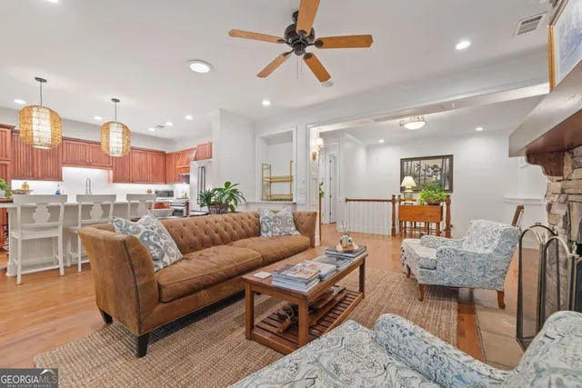 a view of a dining room with furniture a chandelier and wooden floor