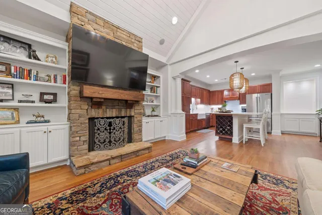 a living room with furniture a rug and a chandelier