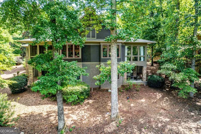 a front view of a house with a yard and potted plants