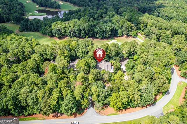 a view of a house with wooden deck front of house