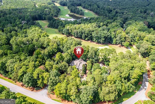 an open kitchen with wooden floor and furniture