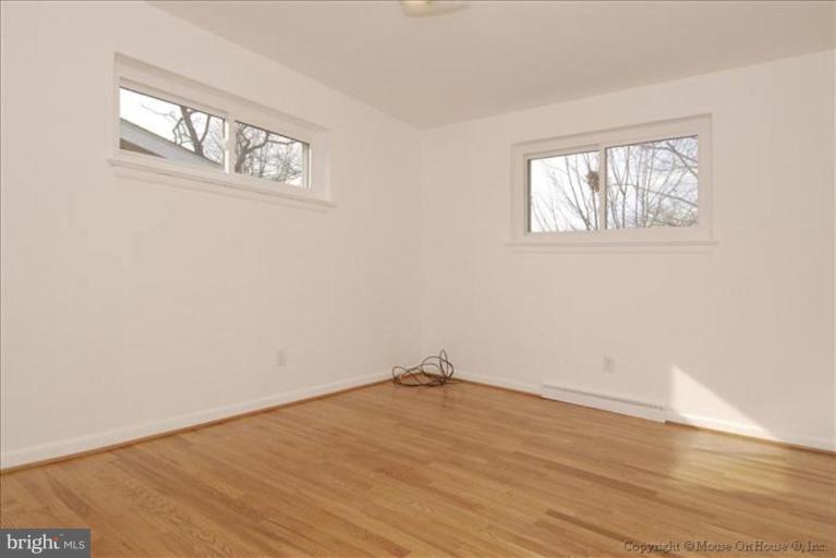 10114 Renfrew Road Silver Spring, MD 20901 - Photo 13 of 27 a view of empty room with wooden floor and fan