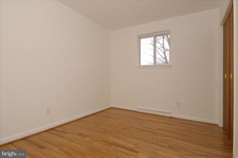 10114 Renfrew Road Silver Spring, MD 20901 - Photo 14 of 27 an empty room with wooden floor and windows