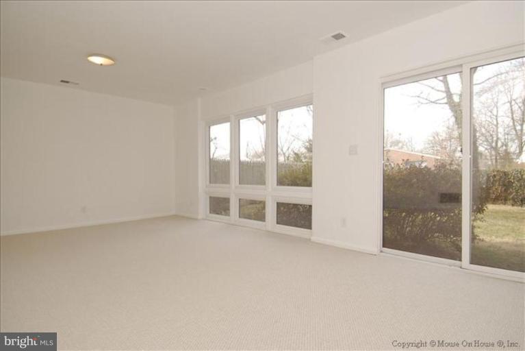 10114 Renfrew Road Silver Spring, MD 20901 - Photo 21 of 27 a view of an empty room with a large window