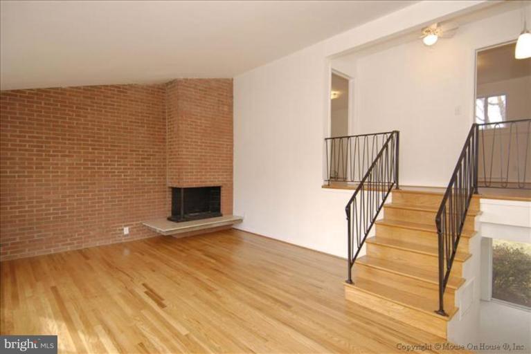 10114 Renfrew Road Silver Spring, MD 20901 - Photo 25 of 27 a view of an empty room with wooden floor and stairs
