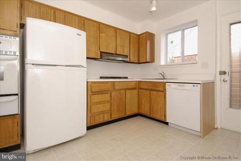 10114 Renfrew Road Silver Spring, MD 20901 - Photo 7 of 27 a kitchen with cabinets a refrigerator and a sink