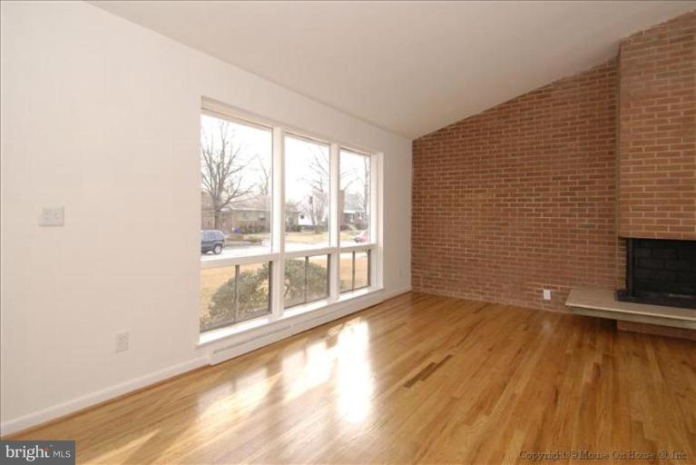 10114 Renfrew Road Silver Spring, MD 20901 - Photo 9 of 27 a view of an empty room with wooden floor and a window