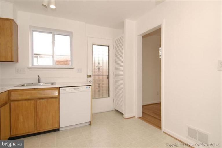 10114 Renfrew Road Silver Spring, MD 20901 - Photo 10 of 27 a utility room with cabinets washer and dryer