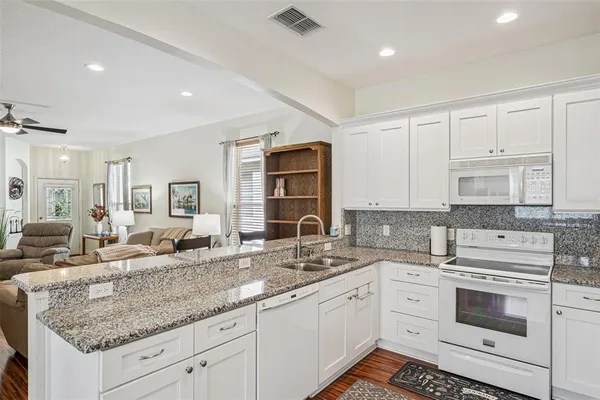 a kitchen with granite countertop a sink and cabinets