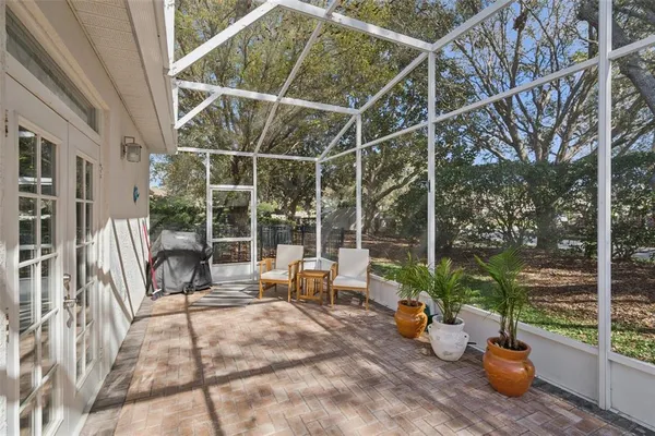 a view of a balcony with chairs and potted plants