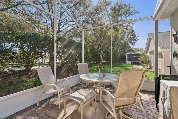 a view of a patio with a table chairs and a backyard