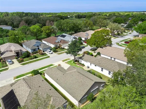 an aerial view of residential houses with outdoor space and street view