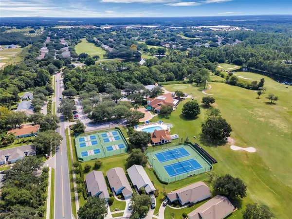 an aerial view of residential house with outdoor space and parking