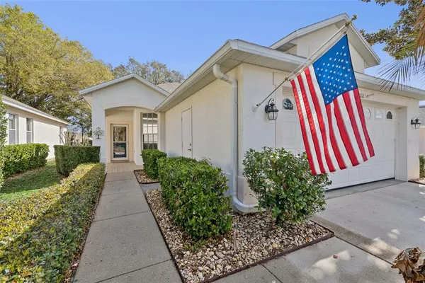 a view of a house with a yard and plants