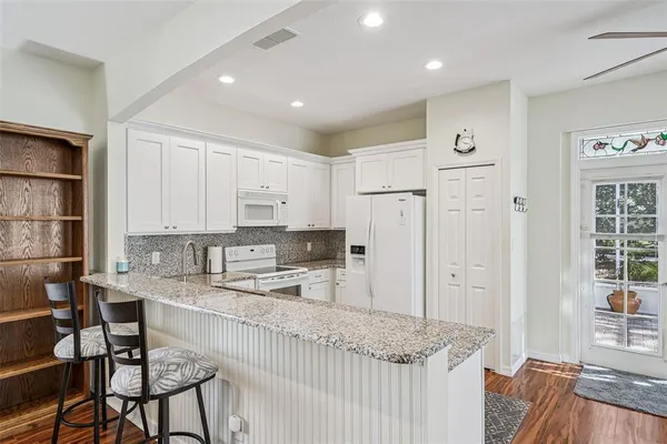 a kitchen with stainless steel appliances granite countertop a refrigerator sink and cabinets