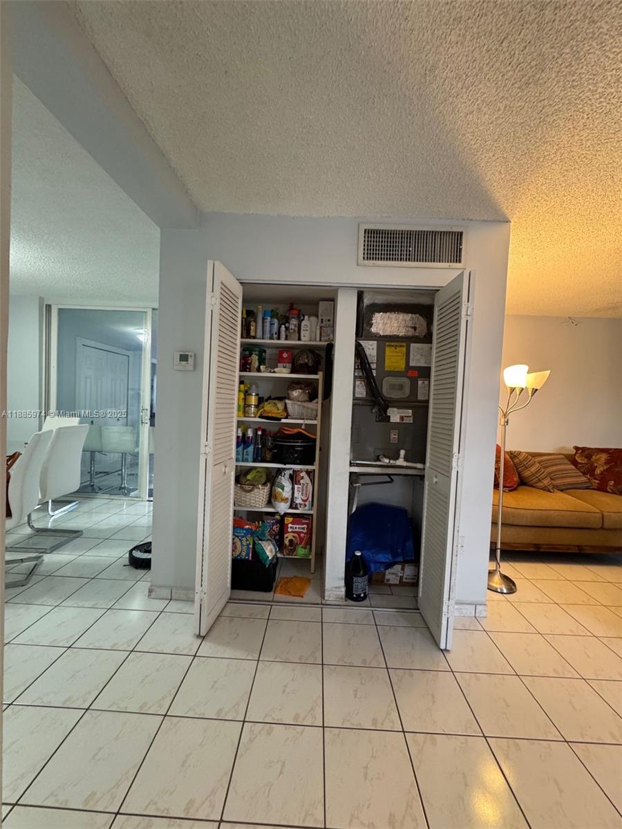 2410 Southwest 122nd Court, Unit 1 Miami, FL 33175 - Photo 12 of 26 a view of walk in closet with clothes and shoes