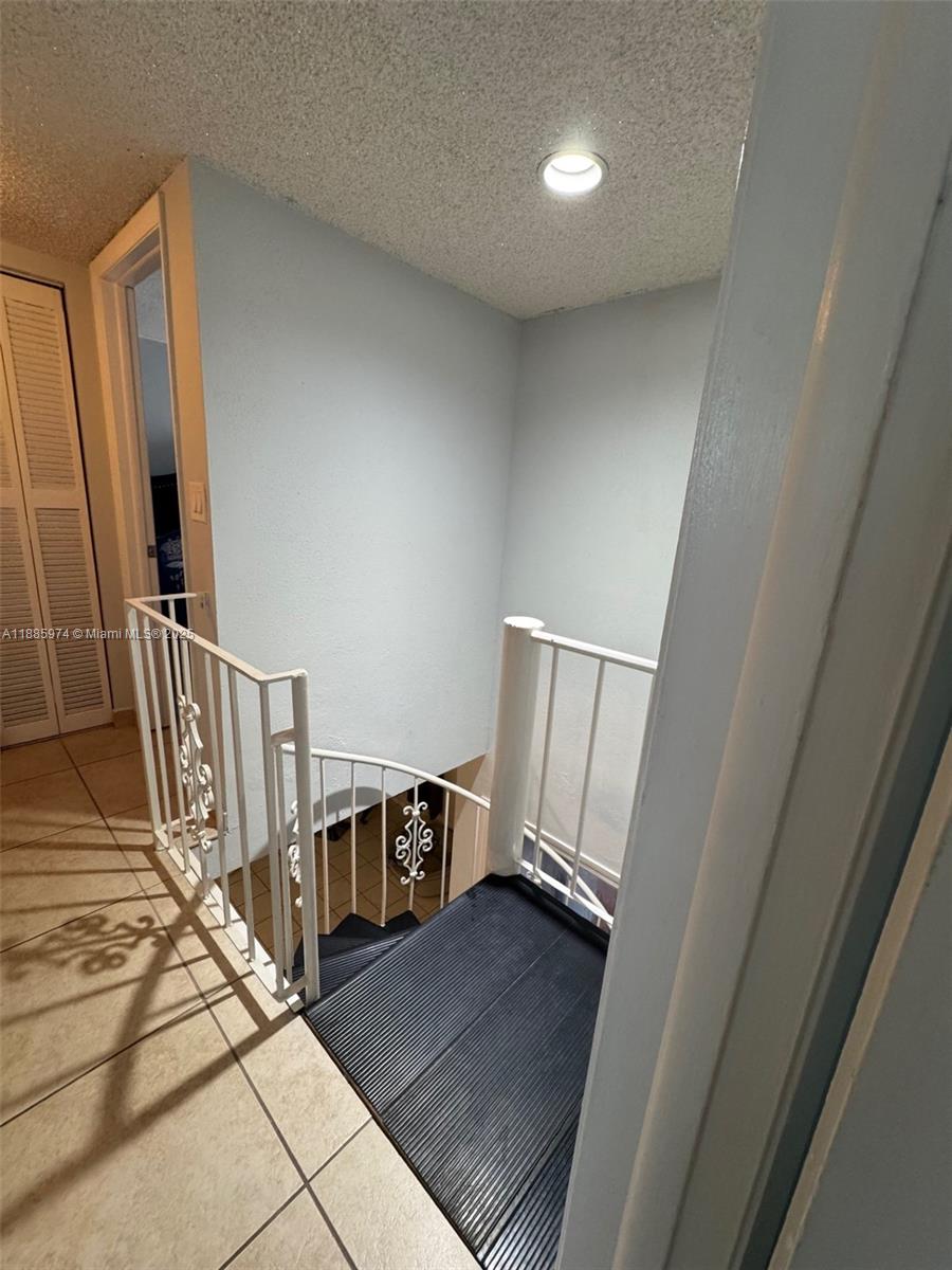 2410 Southwest 122nd Court, Unit 1 Miami, FL 33175 - Photo 13 of 26 a view of a hallway to a livingroom with wooden floor and staircase