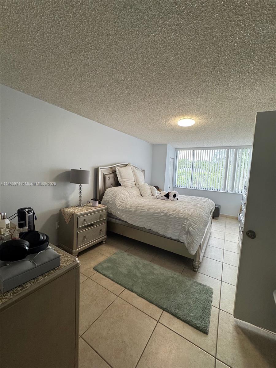 2410 Southwest 122nd Court, Unit 1 Miami, FL 33175 - Photo 16 of 26 a bedroom with bed and window