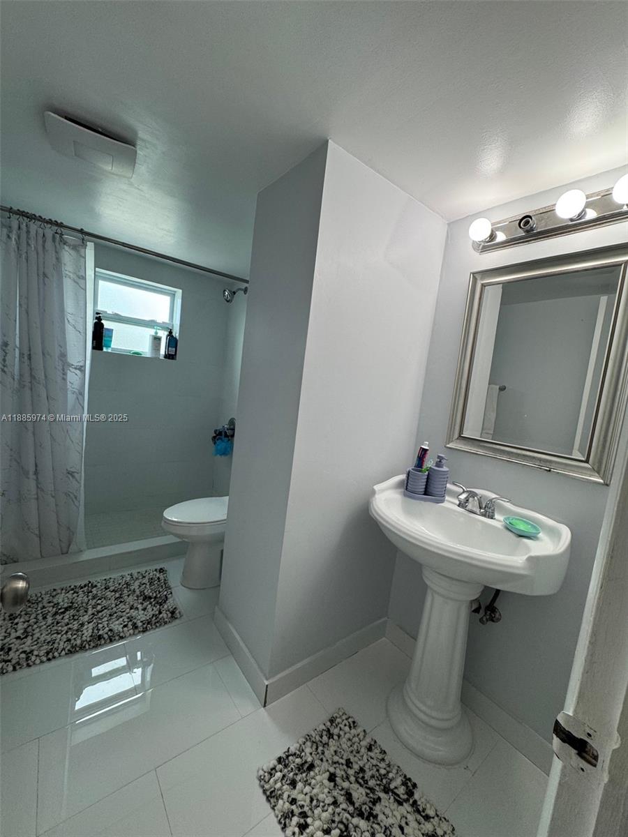 2410 Southwest 122nd Court, Unit 1 Miami, FL 33175 - Photo 19 of 26 a bathroom with a sink toilet and shower