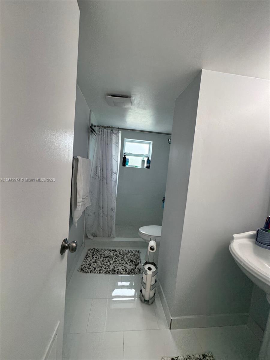 2410 Southwest 122nd Court, Unit 1 Miami, FL 33175 - Photo 20 of 26 a bathroom with a sink toilet and shower