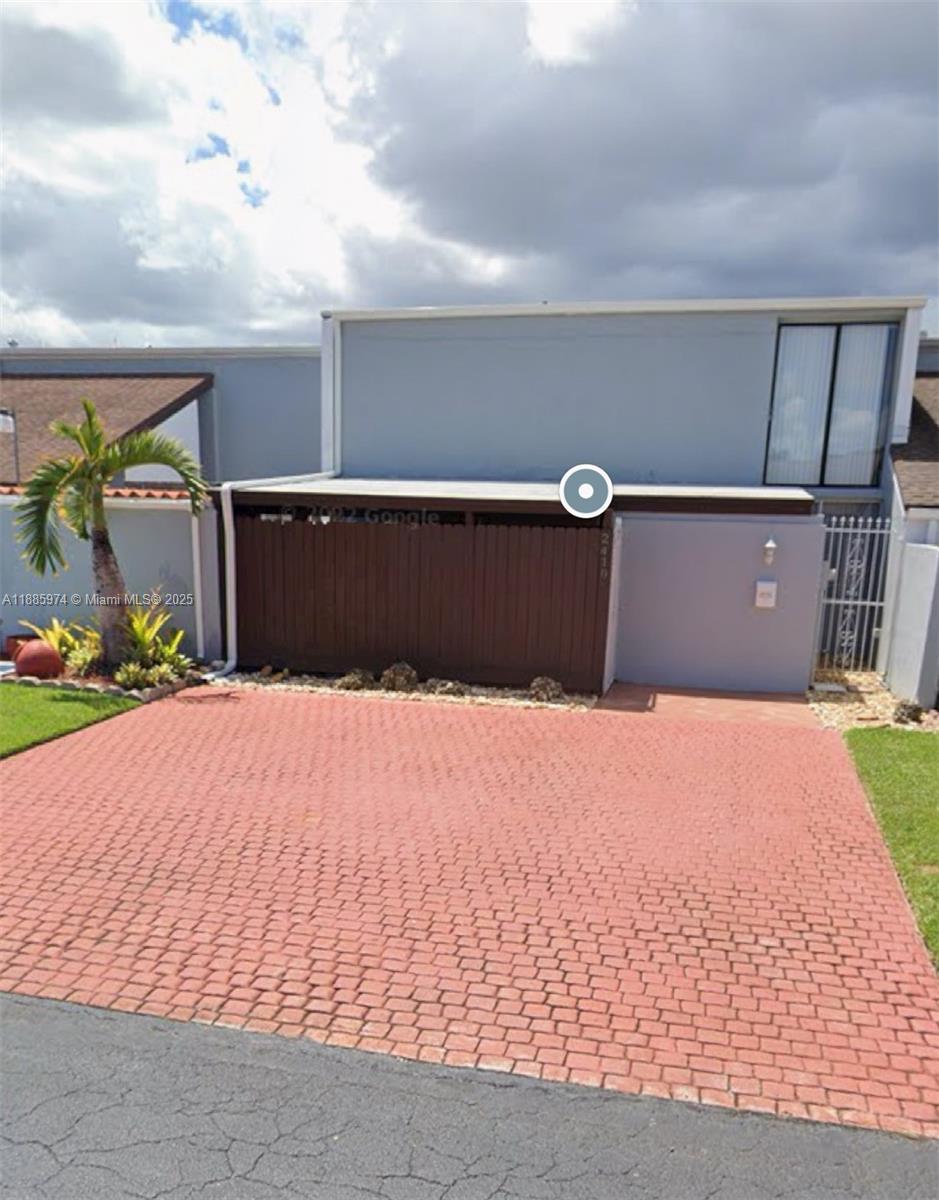 2410 Southwest 122nd Court, Unit 1 Miami, FL 33175 - Photo 2 of 26 a front view of a house with a yard