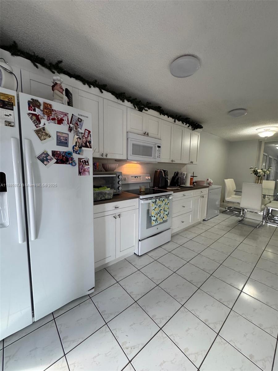 2410 Southwest 122nd Court, Unit 1 Miami, FL 33175 - Photo 6 of 26 a kitchen with stainless steel appliances granite countertop a refrigerator and a sink