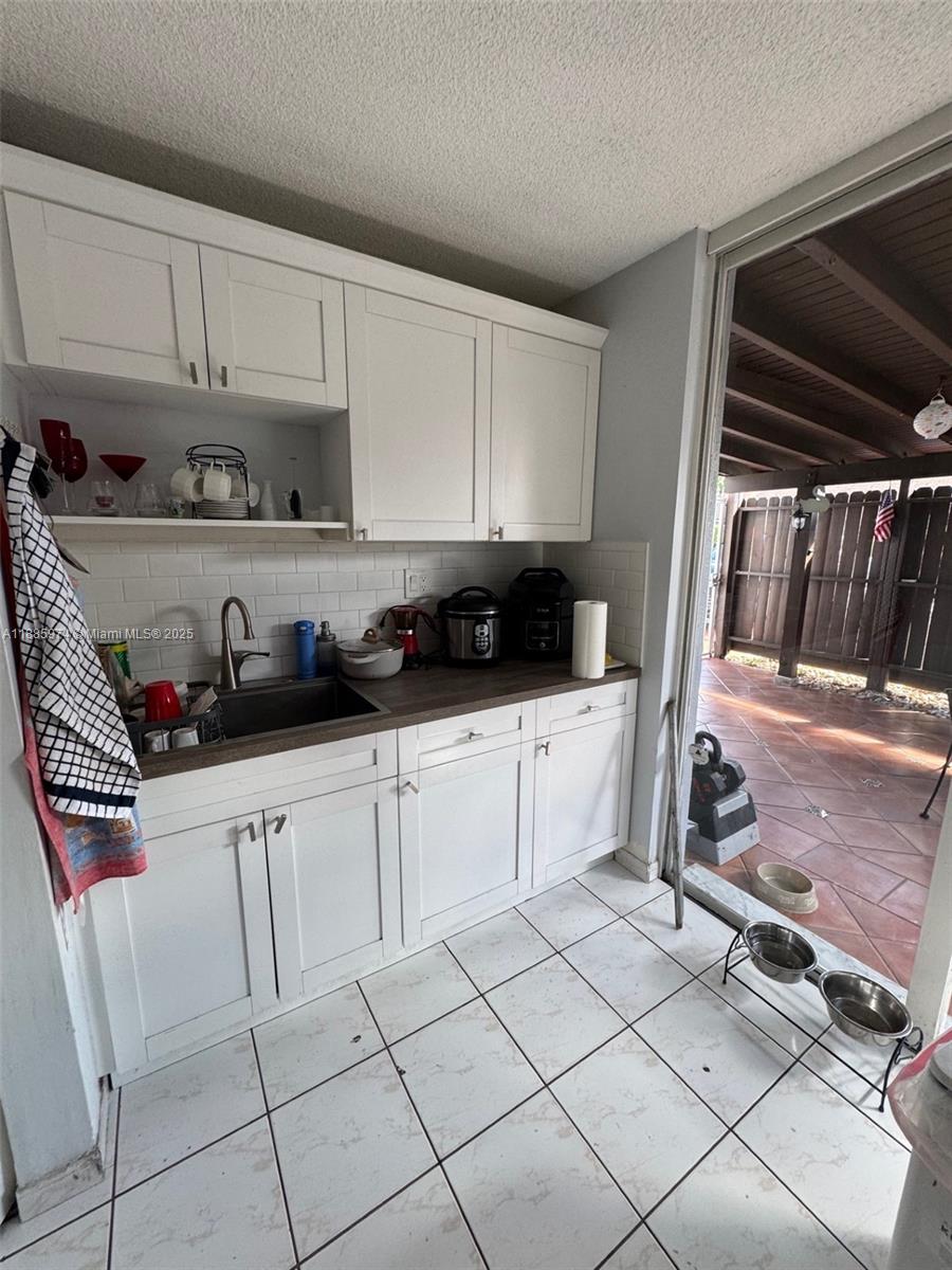 2410 Southwest 122nd Court, Unit 1 Miami, FL 33175 - Photo 7 of 26 a kitchen with cabinets and appliances