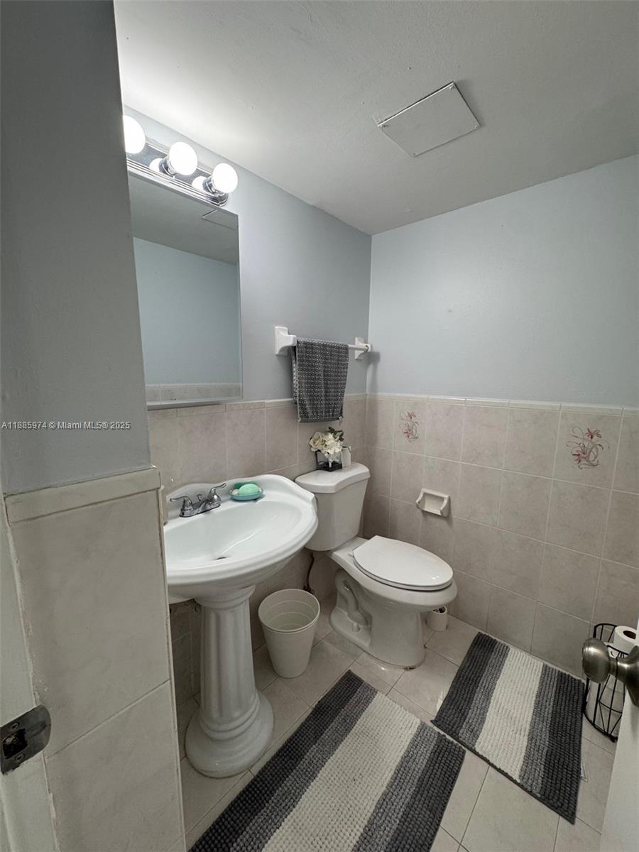 2410 Southwest 122nd Court, Unit 1 Miami, FL 33175 - Photo 9 of 26 a white toilet sitting next to a bathroom sink