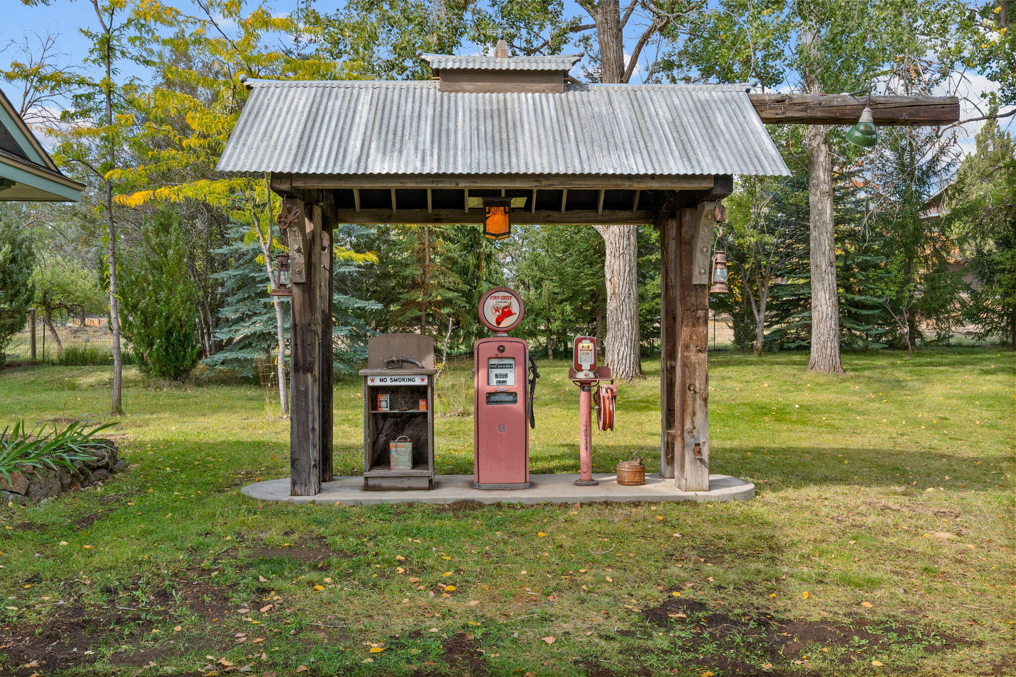 21925 Bear Creek Road Bend, OR 97702 - Photo 71 of 104 Decorative gas pump with lights, hand made lamps and old timber beams salvaged from a Bend barn