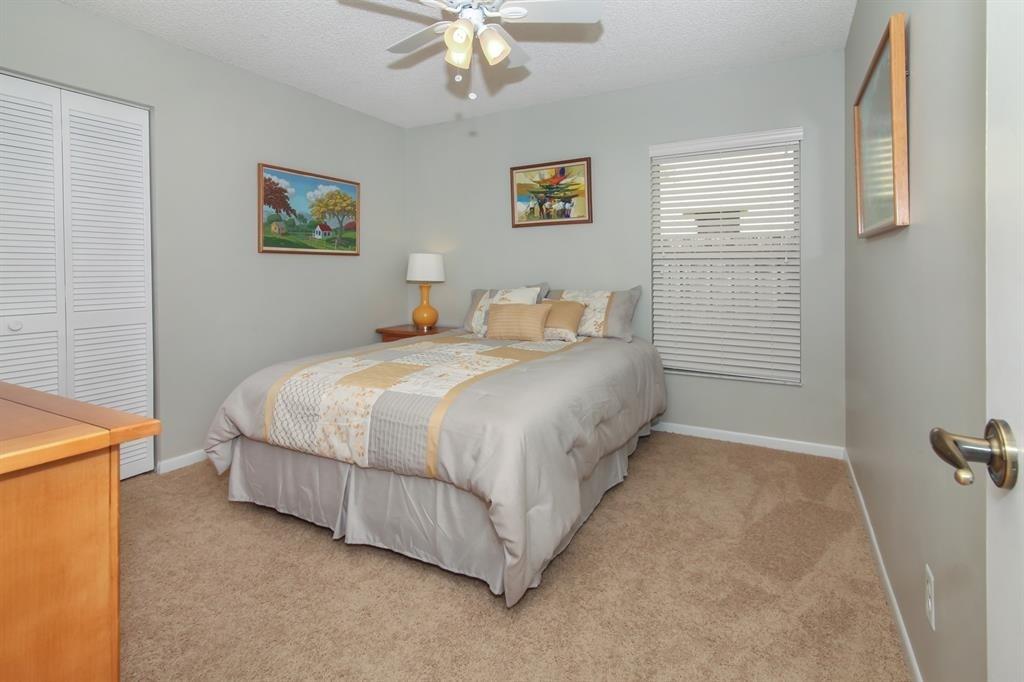 5737 Southwest 89th Way Cooper City, FL 33328 - Photo 15 of 23 a bedroom with a bed and a chandelier
