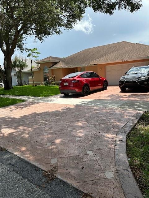 5737 Southwest 89th Way Cooper City, FL 33328 - Photo 20 of 23 a couple of cars parked in front of a house