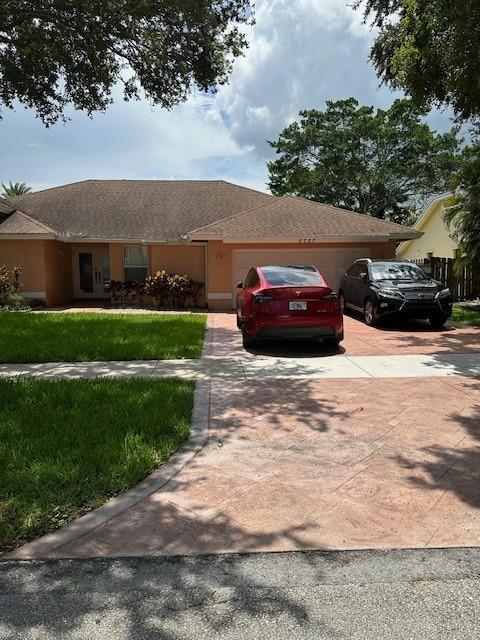 5737 Southwest 89th Way Cooper City, FL 33328 - Photo 21 of 23 a view of a yard with a car parked in front of it