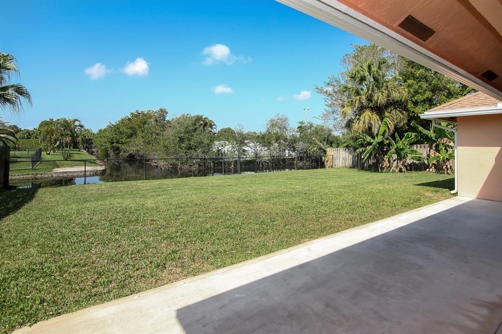 5737 Southwest 89th Way Cooper City, FL 33328 - Photo 3 of 23 a view of a garden with a building in the background