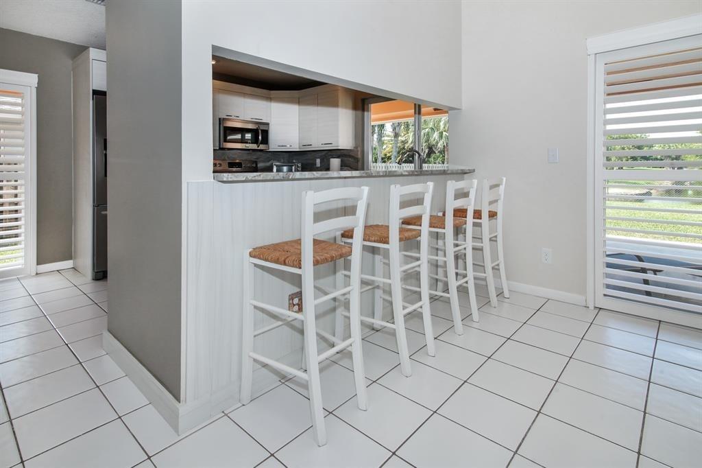 5737 Southwest 89th Way Cooper City, FL 33328 - Photo 6 of 23 a kitchen with stainless steel appliances a refrigerator and a stove top oven