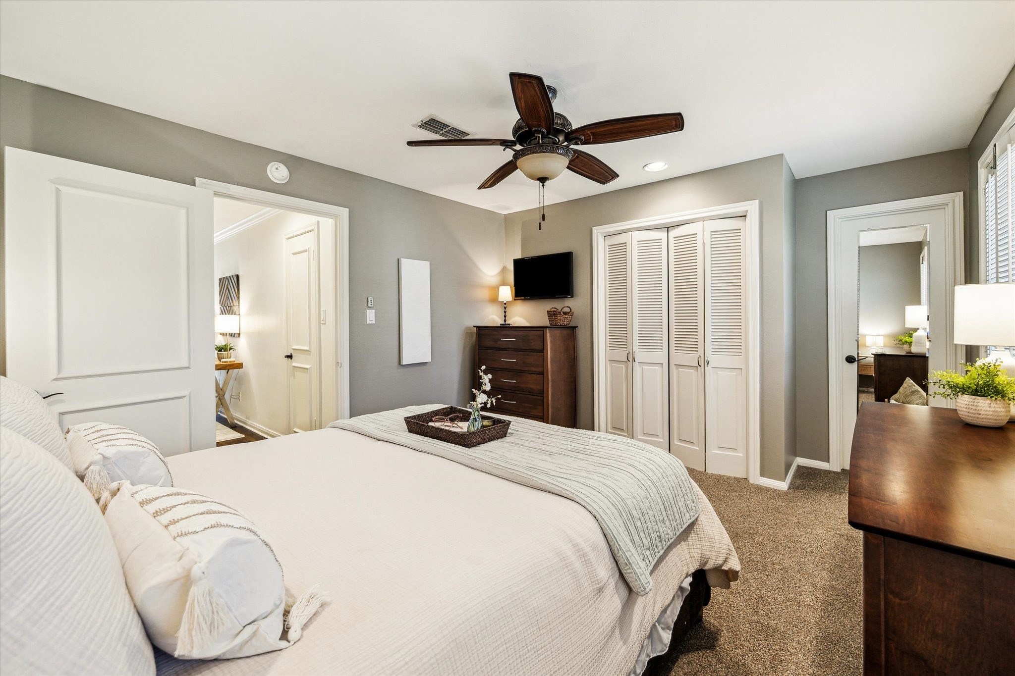 7523 Del Monte Drive Houston, TX 77063 - Photo 17 of 41 a bedroom with a bed and a chandelier