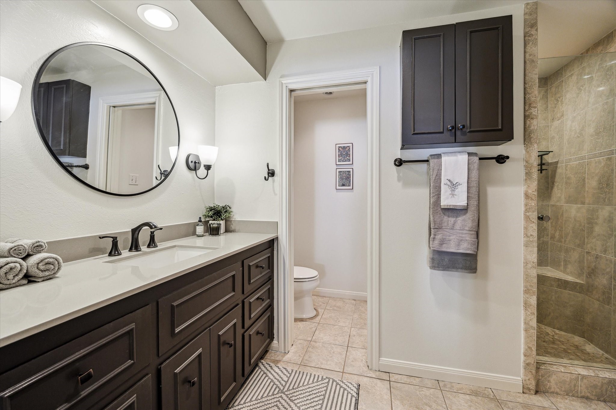 7523 Del Monte Drive Houston, TX 77063 - Photo 22 of 41 a spacious bathroom with a double vanity sink toilet and shower