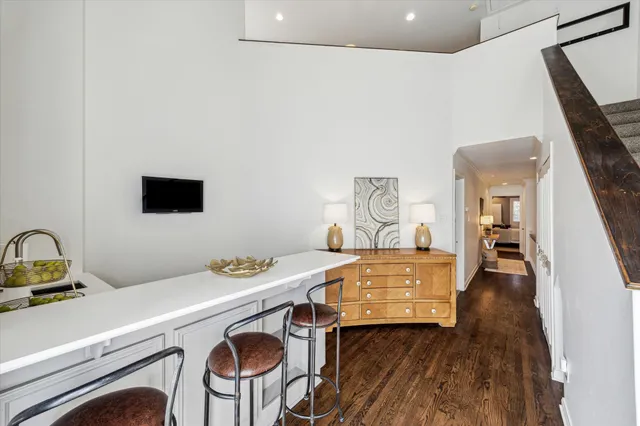 a room with a table chairs and wooden floor
