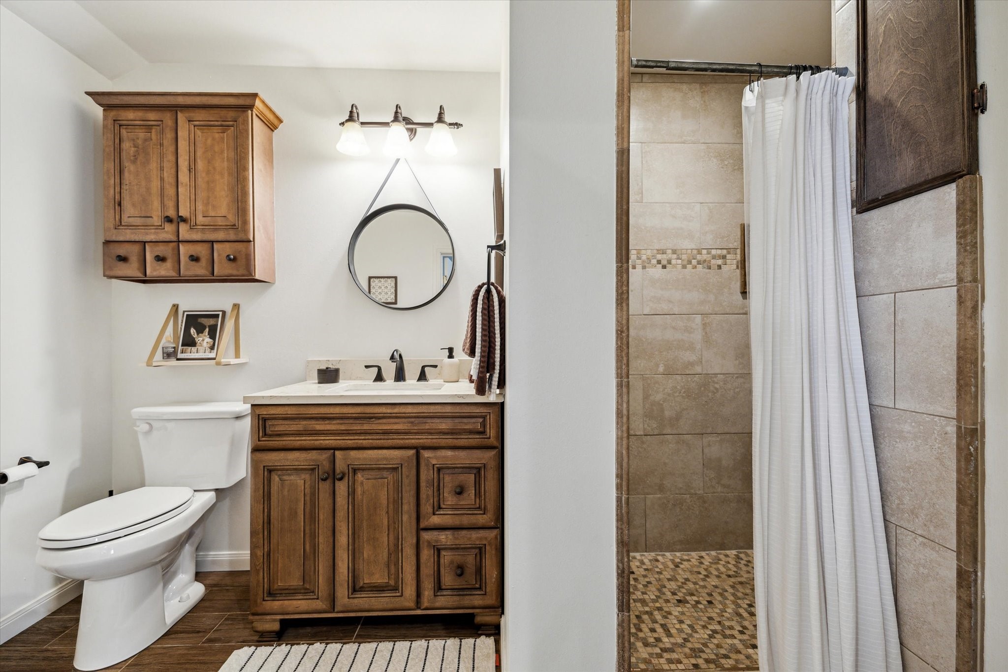 7523 Del Monte Drive Houston, TX 77063 - Photo 33 of 41 a bathroom with a toilet sink vanity and shower