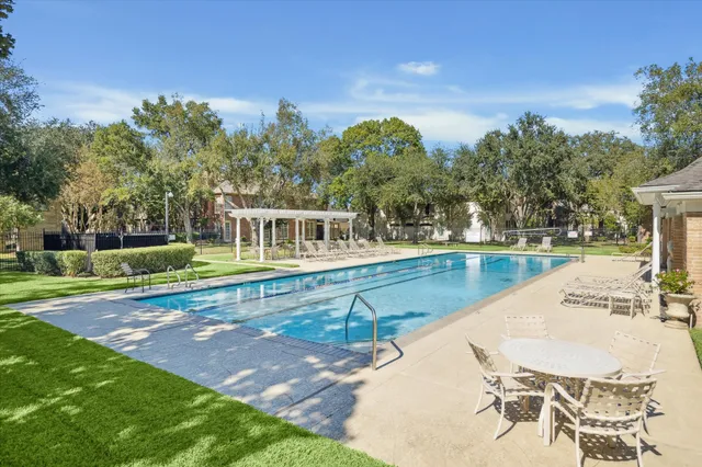 a view of a swimming pool with an outdoor seating