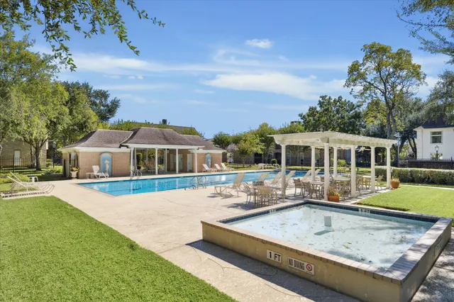 a view of a house with swimming pool and sitting area