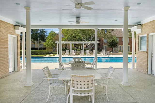 a view of a dining room with furniture large windows and wooden floor