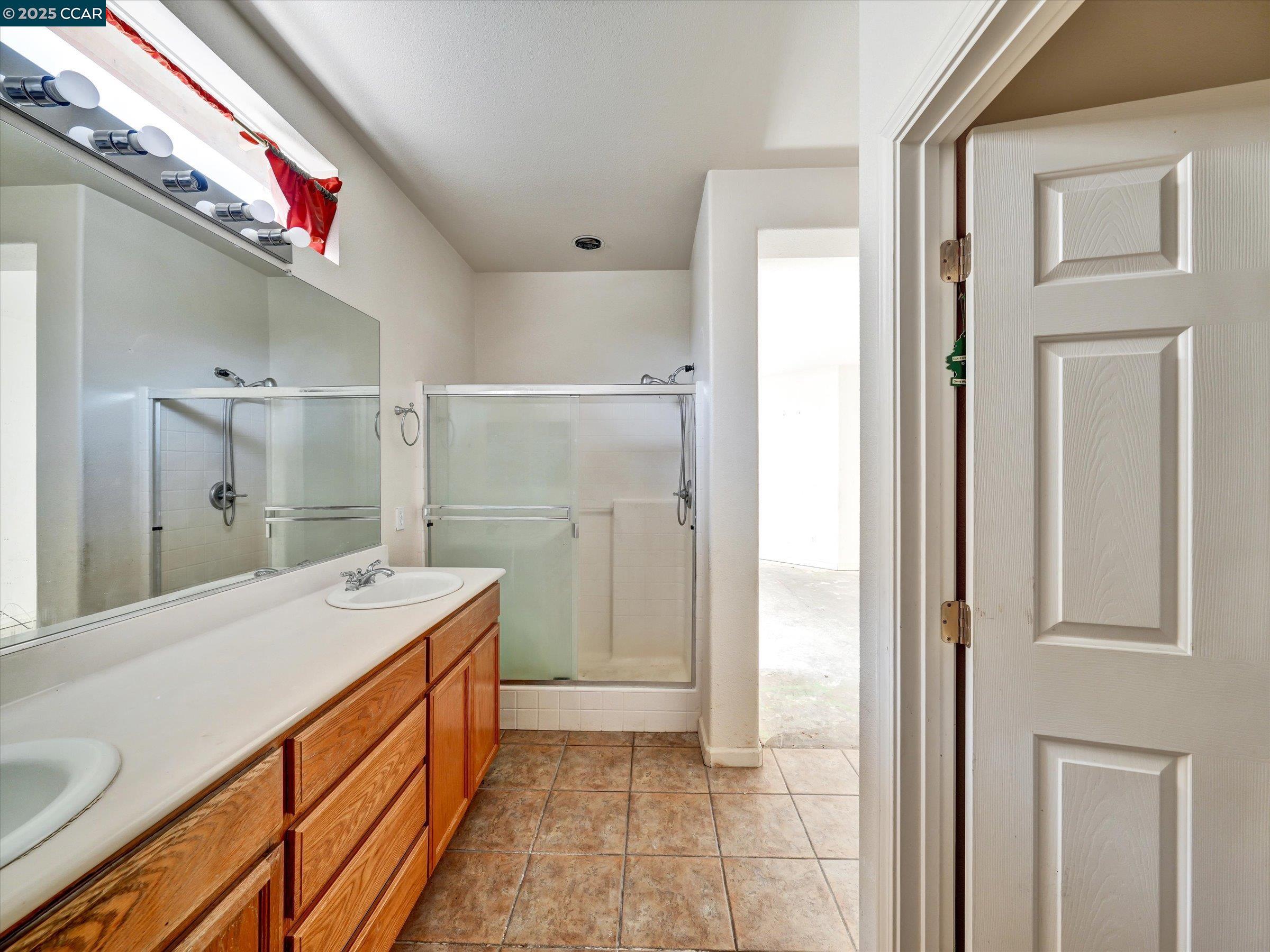 329 Brockton Place Rio Vista, CA 94571 - Photo 16 of 29 a bathroom with a sink a mirror and a shower