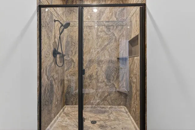 a bathroom with a glass shower door