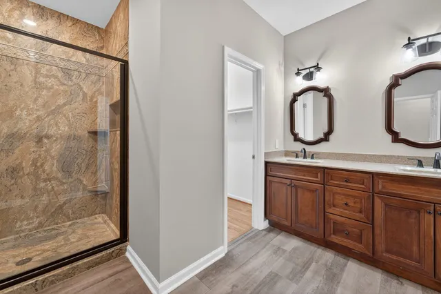 a bathroom with double vanity sink and a mirror
